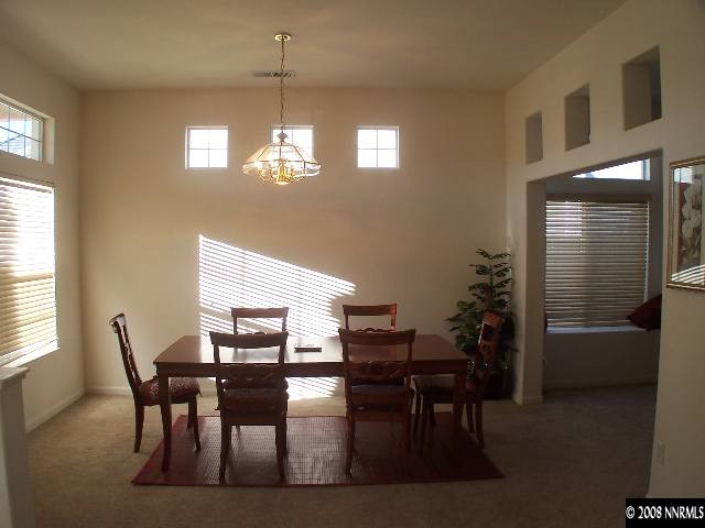 10450 Arbor Way Reno, NV 89521 - Photo 3 of 9 a view of a dining room with furniture and chandelier