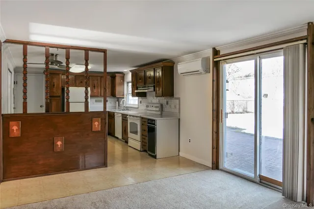 a kitchen with stainless steel appliances granite countertop a refrigerator a stove a sink and a microwave