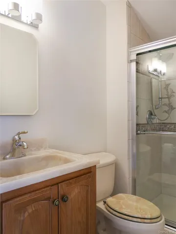 a view of an empty room with a mirror and a fan