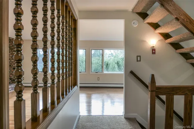 a view of a room with wooden floor and a window