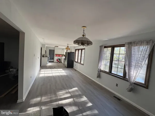a open kitchen with stainless steel appliances kitchen island a stove and a refrigerator