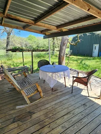 a view of a patio with lawn chairs floor to ceiling window with wooden floor