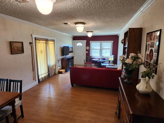 a living room with furniture window and wooden floor