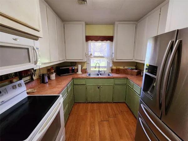 a kitchen with a refrigerator and a sink