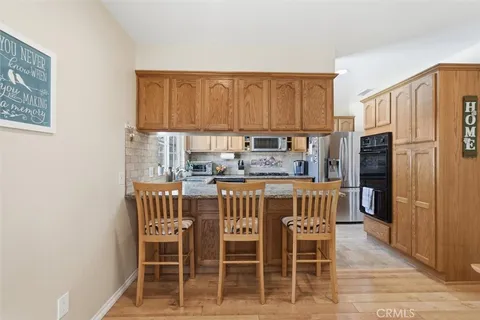 a kitchen with granite countertop stainless steel appliances a stove a sink a microwave and cabinets