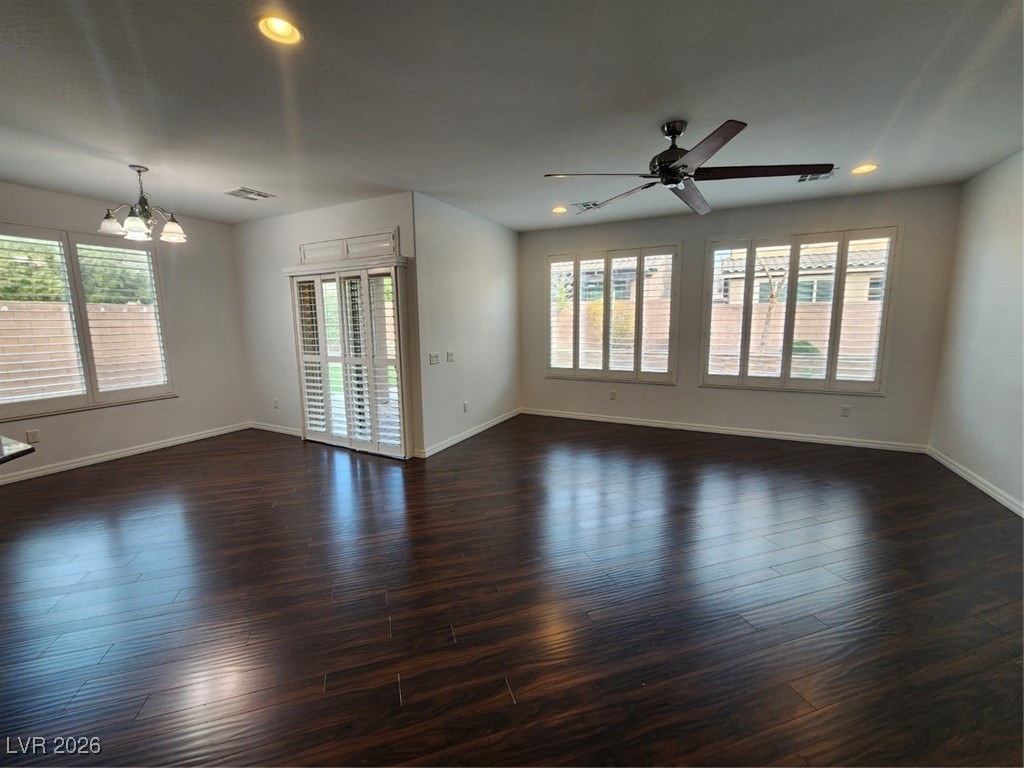 7022 Cordite Road Las Vegas, NV 89178 - Photo 13 of 51 Spare room featuring a chandelier, recessed lighting, a ceiling fan, and dark wood-type flooring