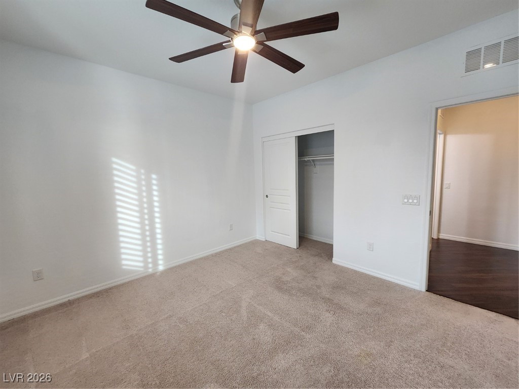 7022 Cordite Road Las Vegas, NV 89178 - Photo 17 of 51 Unfurnished bedroom featuring carpet, a closet, and ceiling fan