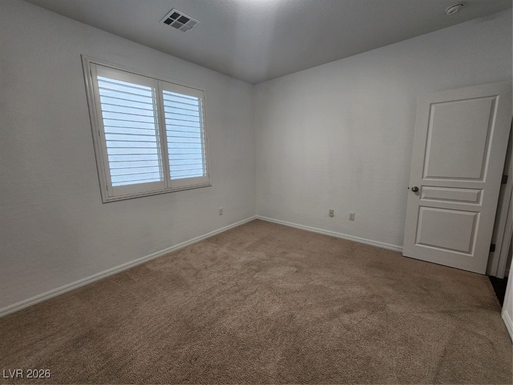 7022 Cordite Road Las Vegas, NV 89178 - Photo 23 of 51 Empty room featuring carpet floors and baseboards
