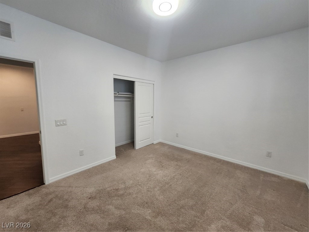 7022 Cordite Road Las Vegas, NV 89178 - Photo 25 of 51 Unfurnished bedroom featuring carpet and a closet