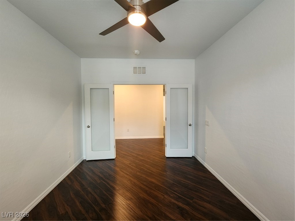 7022 Cordite Road Las Vegas, NV 89178 - Photo 27 of 51 Spare room with dark wood finished floors and baseboards