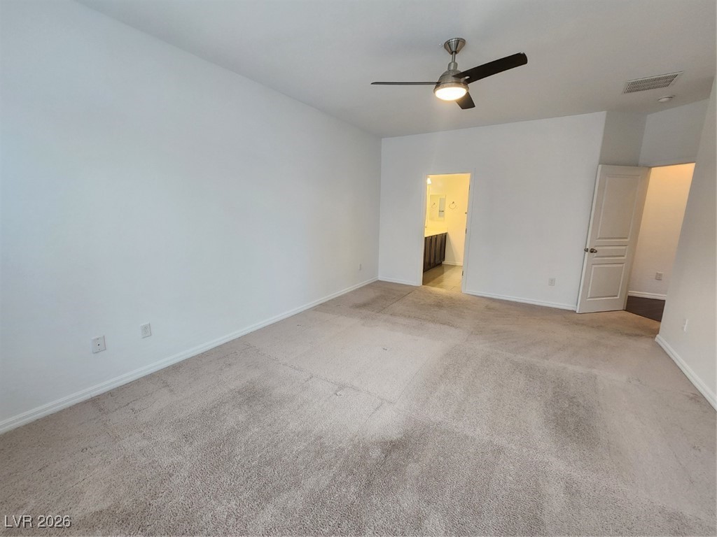 7022 Cordite Road Las Vegas, NV 89178 - Photo 29 of 51 Unfurnished bedroom with carpet floors, ceiling fan, and ensuite bath
