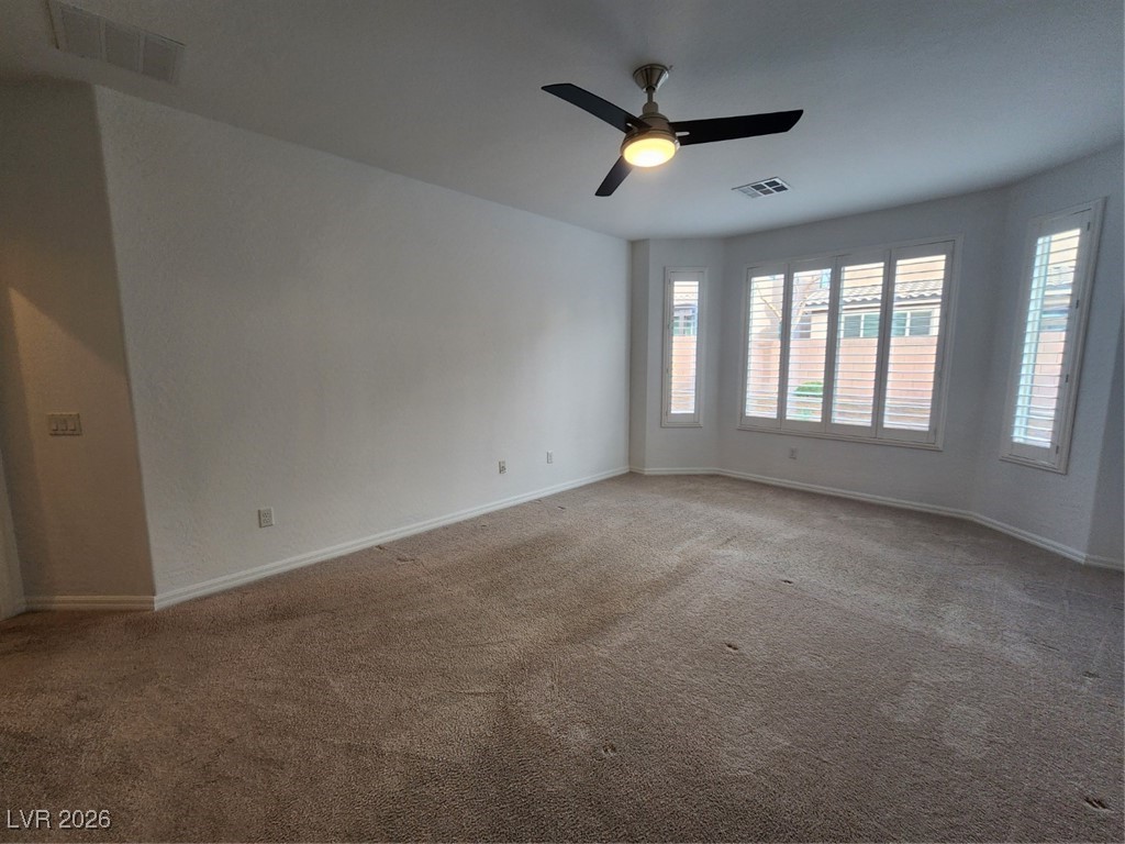 7022 Cordite Road Las Vegas, NV 89178 - Photo 31 of 51 Carpeted spare room with baseboards and ceiling fan