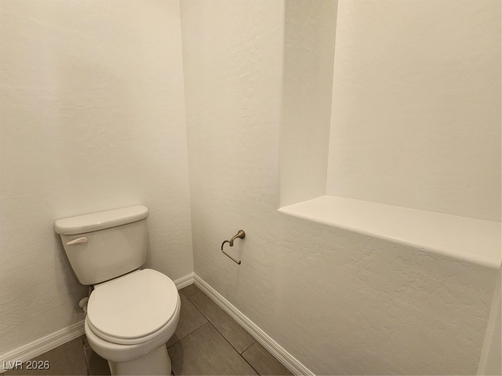 7022 Cordite Road Las Vegas, NV 89178 - Photo 36 of 51 Bathroom with a textured wall and tile patterned flooring