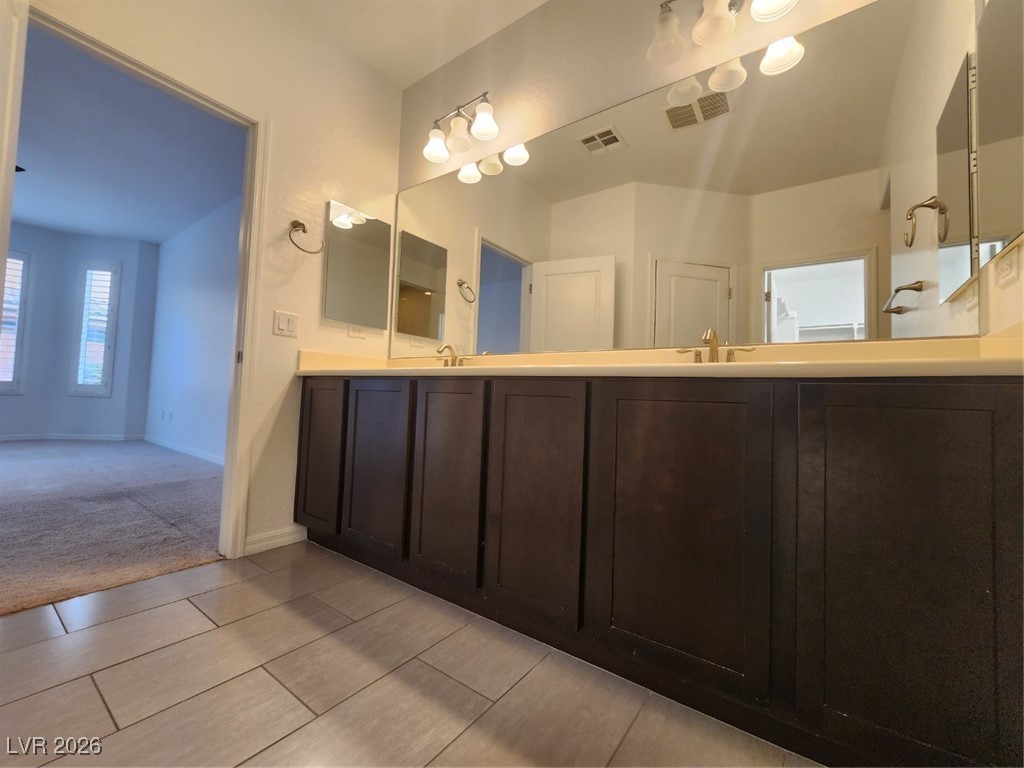 7022 Cordite Road Las Vegas, NV 89178 - Photo 37 of 51 Full bathroom featuring double vanity and light carpet