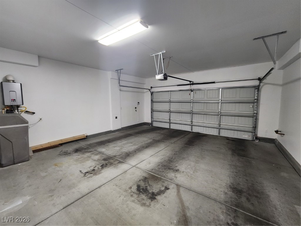 7022 Cordite Road Las Vegas, NV 89178 - Photo 38 of 51 Garage with baseboards and water heater