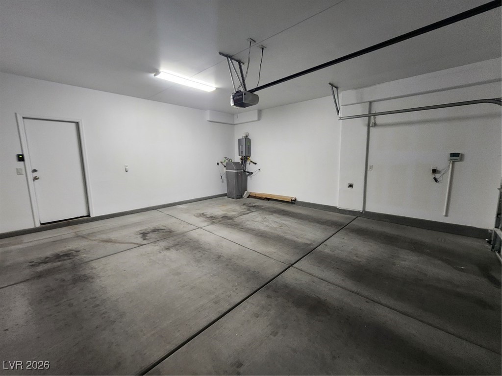 7022 Cordite Road Las Vegas, NV 89178 - Photo 39 of 51 Garage featuring baseboards and a garage door opener