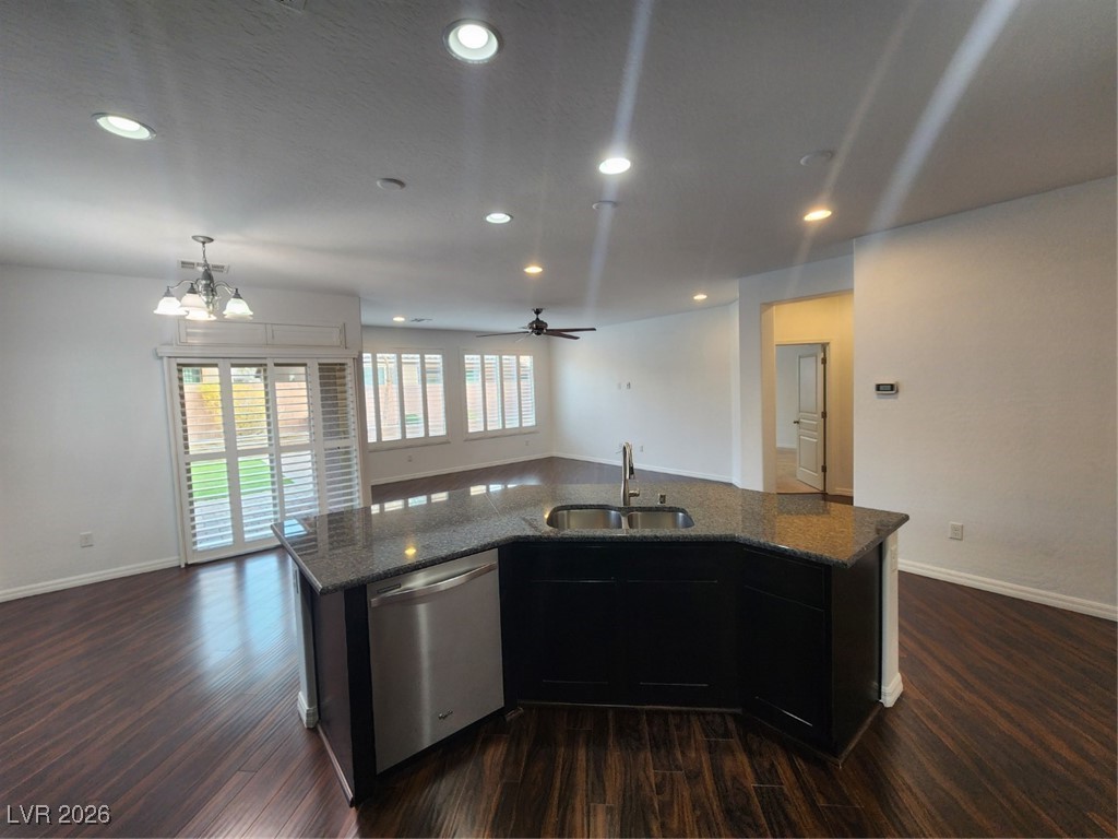 7022 Cordite Road Las Vegas, NV 89178 - Photo 51 of 51 Kitchen with dark cabinets, open floor plan, dishwasher, dark wood-type flooring, and a ceiling fan