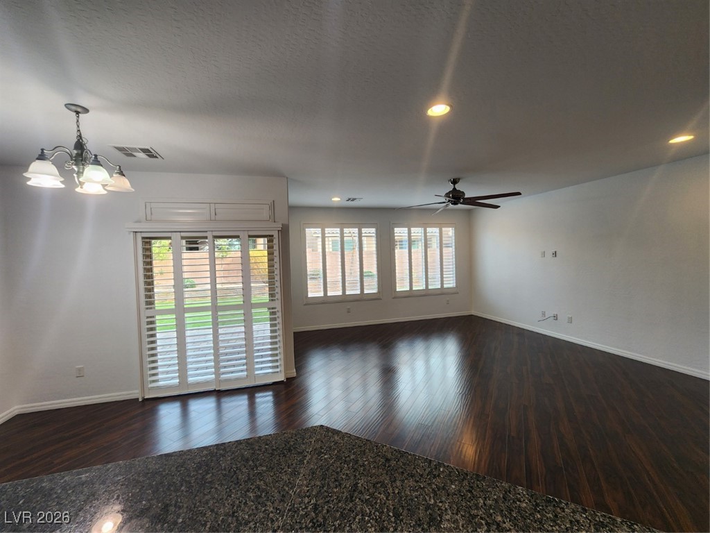 7022 Cordite Road Las Vegas, NV 89178 - Photo 8 of 51 Unfurnished living room featuring dark wood-style floors, a chandelier, recessed lighting, and ceiling fan
