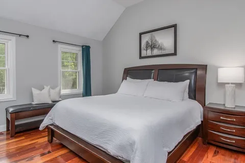 a bedroom with bed and window