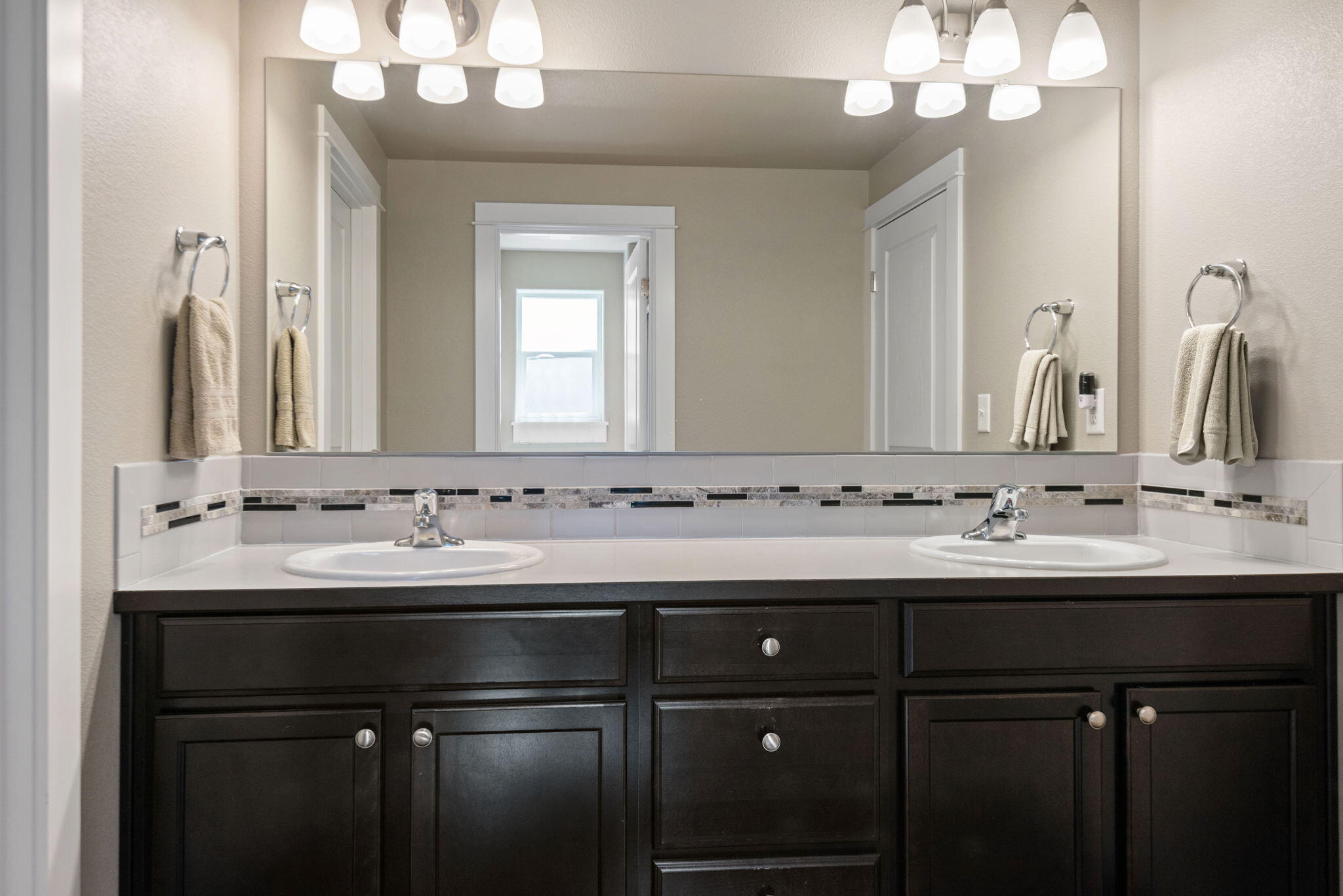 715 Brooks Camp Road Sisters, OR 97759 - Photo 14 of 25 a bathroom with a double vanity sink and a mirror