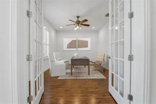 a view of backyard with swimming pool and seating