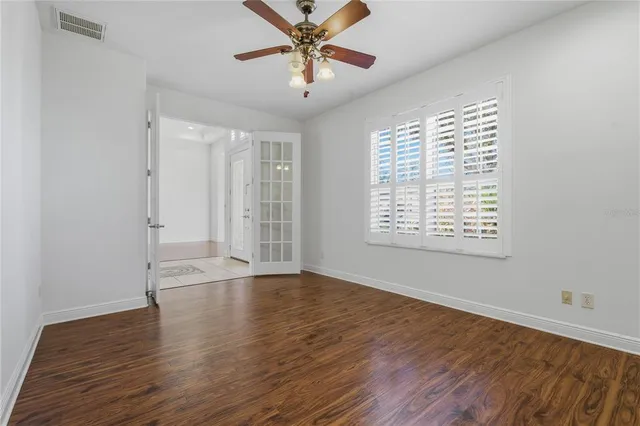 a front view of a house with a yard and palm trees