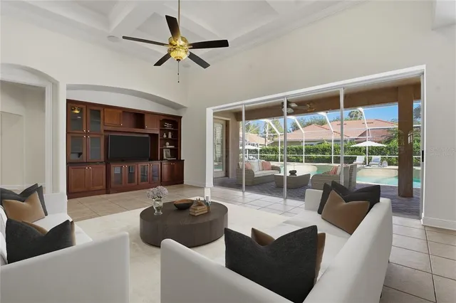a spacious bedroom with a large bed chandelier and a window