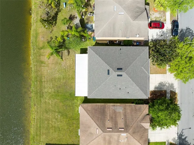 an aerial view of a house with a swimming pool