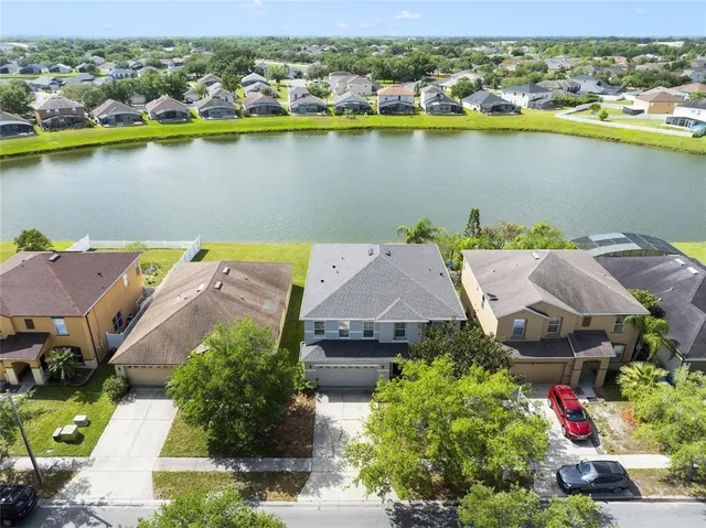an aerial view of a house with a lake view