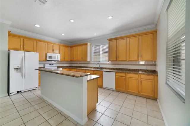 a kitchen with granite countertop cabinets and steel stainless steel appliances