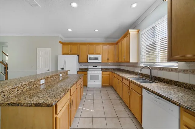 outdoor kitchen with granite countertop kitchen island stainless steel appliances a sink a counter top space and cabinets