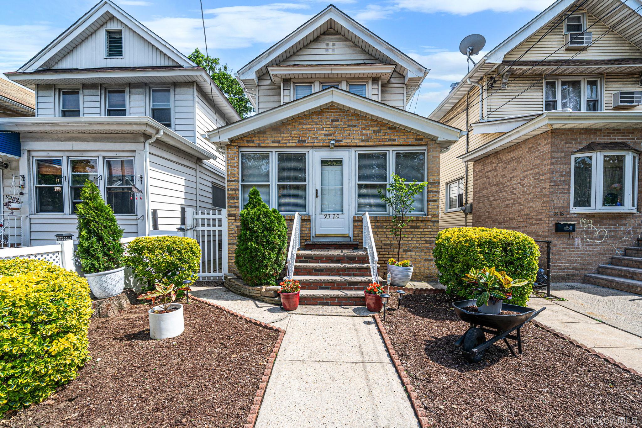 93-20 92nd Avenue Queens, NY 11421 - Photo 1 of 21 a front view of a house with a garden
