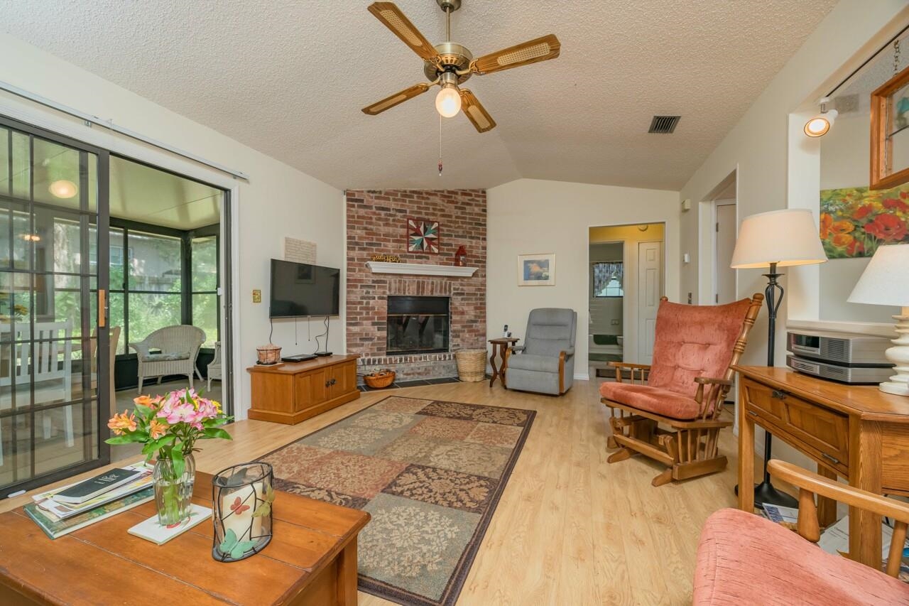 154 Drake Road St. Augustine, FL 32086 - Photo 14 of 36 a living room with furniture fireplace and a flat screen tv