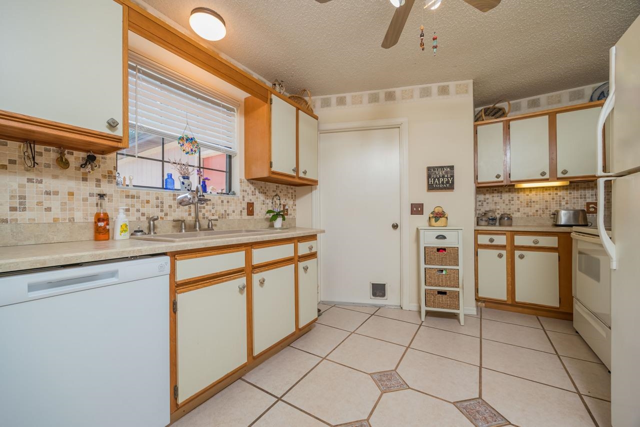154 Drake Road St. Augustine, FL 32086 - Photo 16 of 36 a kitchen with white cabinets and white appliances
