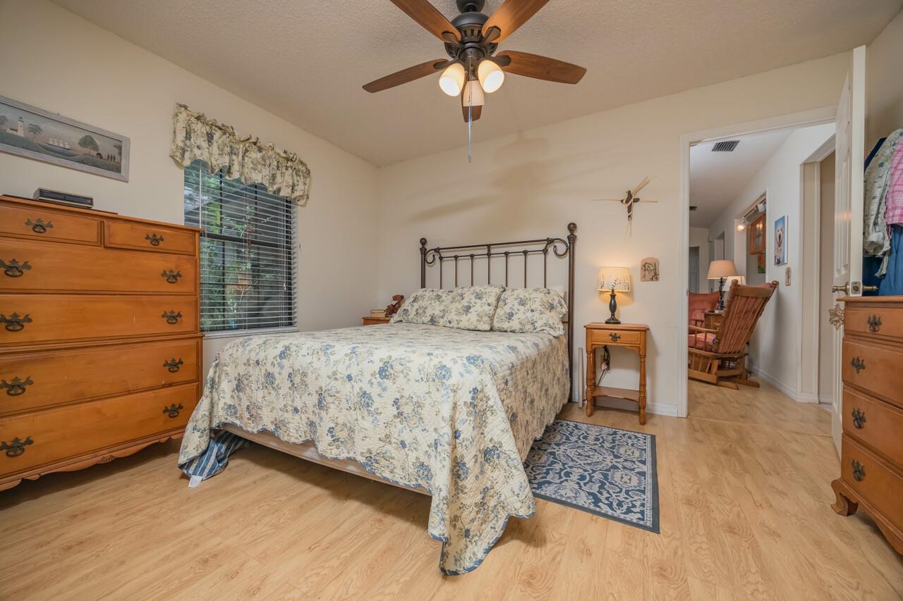 154 Drake Road St. Augustine, FL 32086 - Photo 23 of 36 a bedroom with a bed and a chandelier