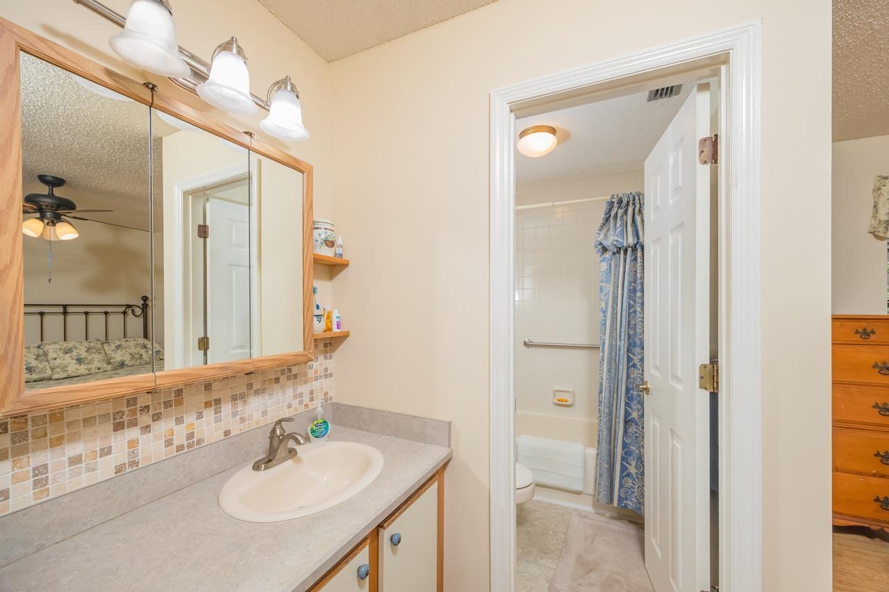 154 Drake Road St. Augustine, FL 32086 - Photo 24 of 36 a bathroom with a sink vanity and a mirror