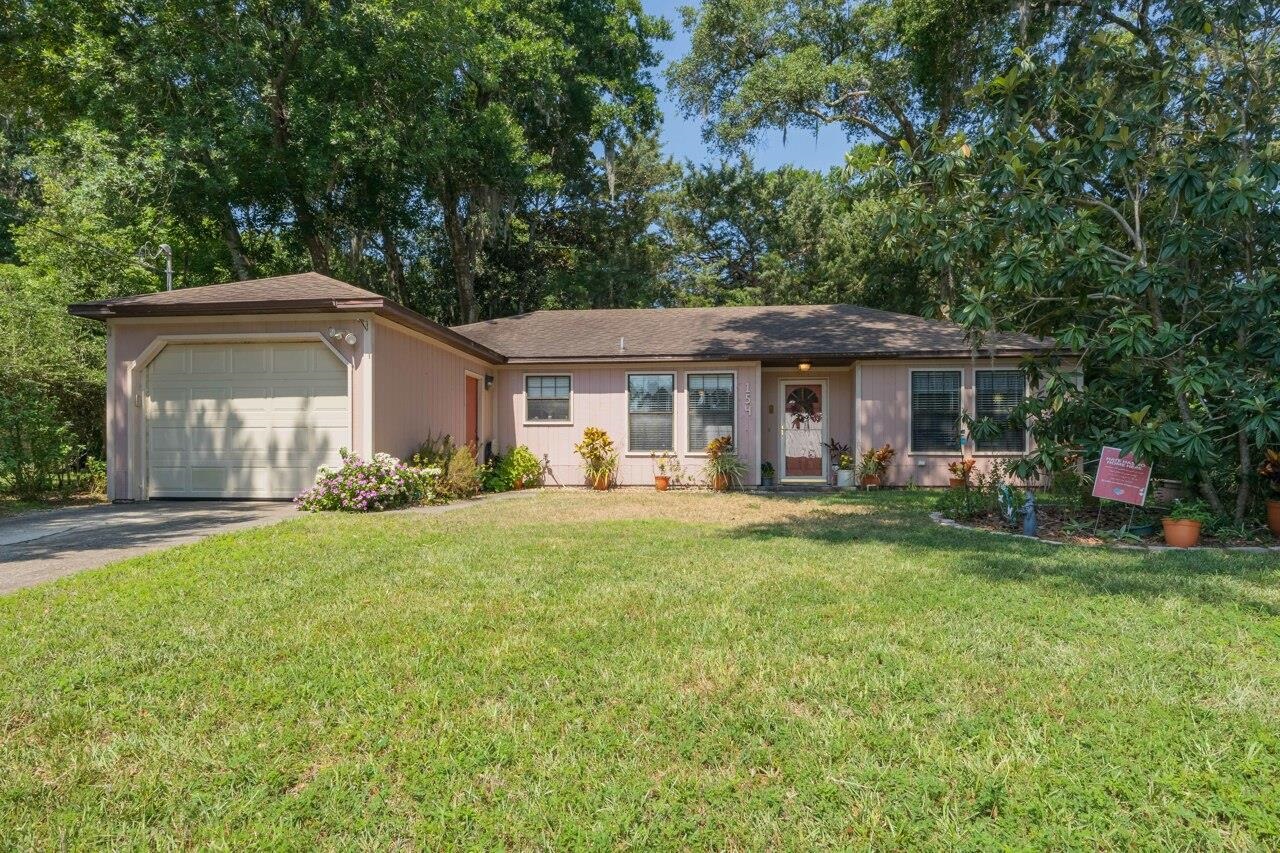 154 Drake Road St. Augustine, FL 32086 - Photo 6 of 36 a front view of a house with a garden and porch