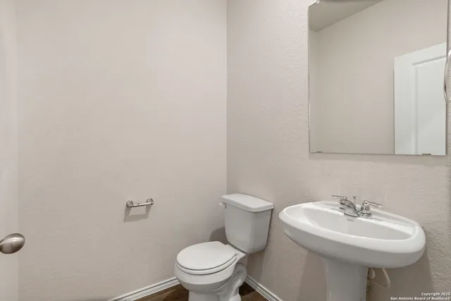 a bathroom with a sink a toilet and mirror