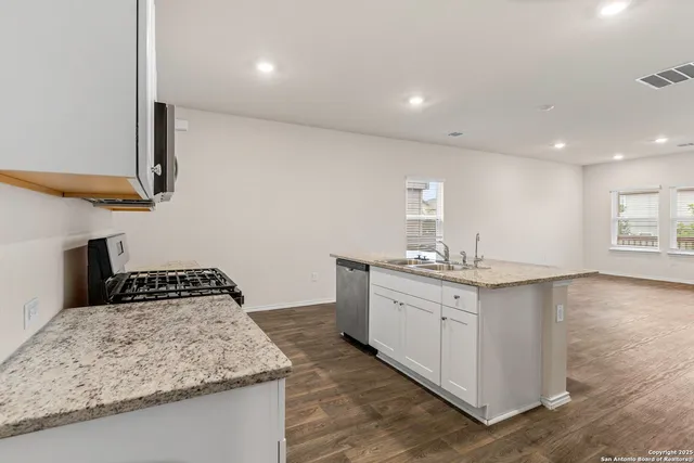 a kitchen with a sink and cabinets