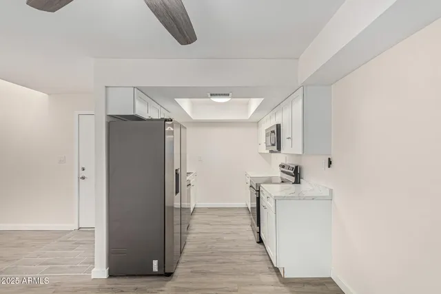 a view of a room with wooden floor closet and windows