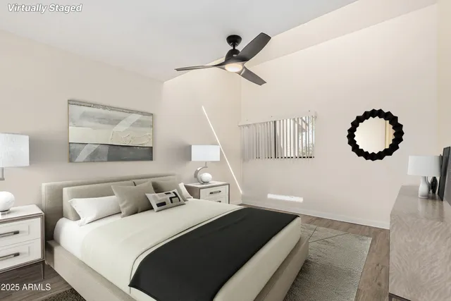 a bedroom with a large bed and a chandelier