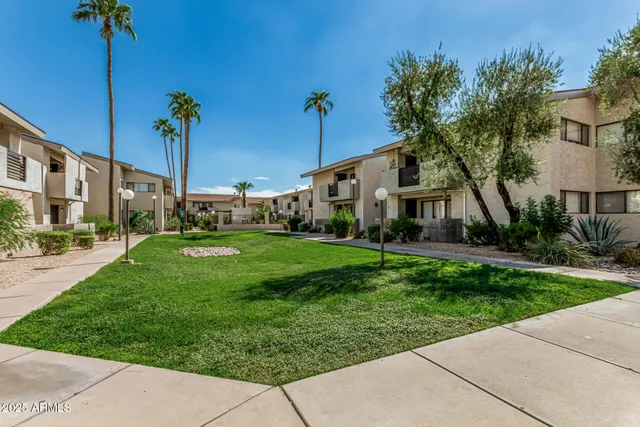 a view of a patio with table and chairs with wooden floor and fence