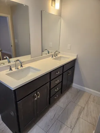 a bathroom with a sink vanity and mirror