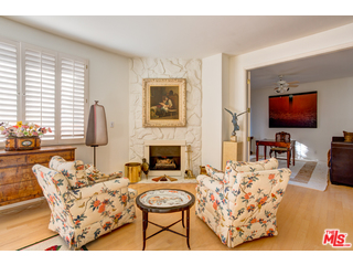 241 South Reeves Drive, Unit 302 Beverly Hills, CA 90212 - Photo 4 of 10 a living room with furniture a fireplace and a flat screen tv