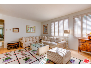 241 South Reeves Drive, Unit 302 Beverly Hills, CA 90212 - Photo 5 of 10 a living room with furniture a flat screen tv and a floor