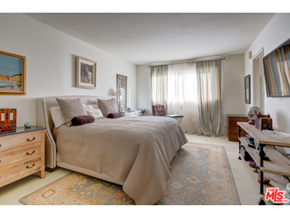 241 South Reeves Drive, Unit 302 Beverly Hills, CA 90212 - Photo 8 of 10 a bedroom with a bed and a night stand