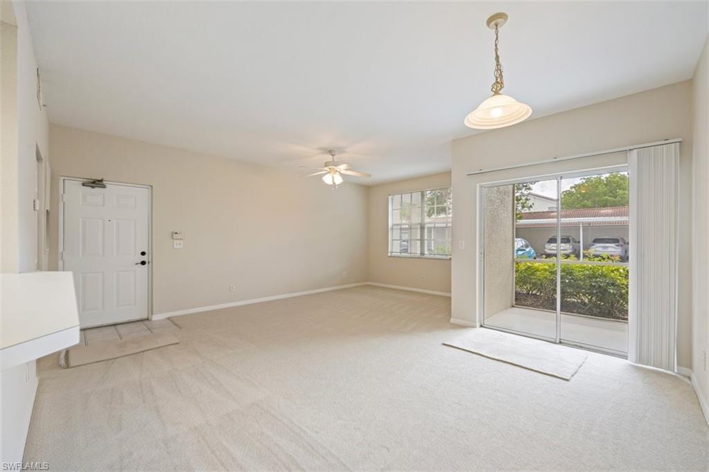 4635 St Croix Lane, Unit 1218 Naples, FL 34109 - Photo 5 of 40 Spare room with light carpet and ceiling fan