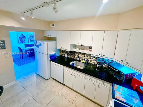 a kitchen with stainless steel appliances a stove a sink and a refrigerator