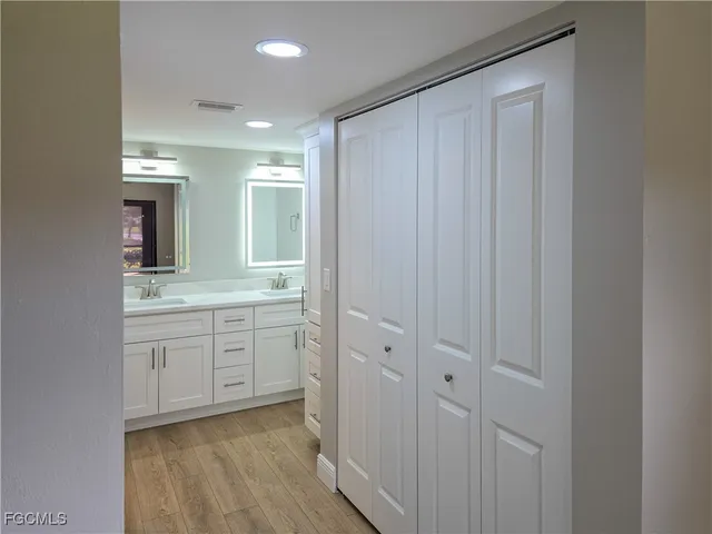 a bathroom with a sink vanity and mirror