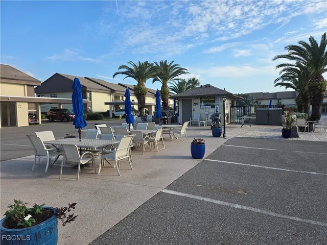 a view of a patio with dining table and chairs with plants